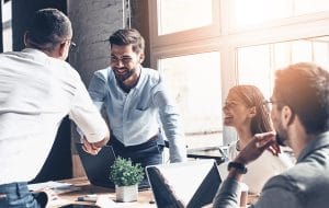 group,of,happy,coworkers,discussing,in,conference,room